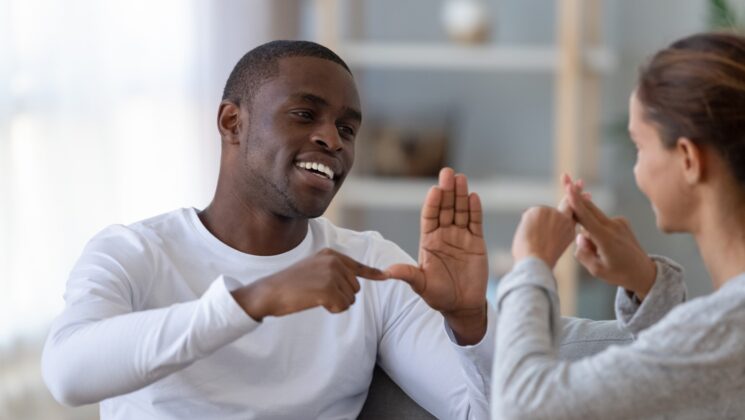 A man and woman having a conversation in sign language