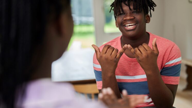 A young man using sign language