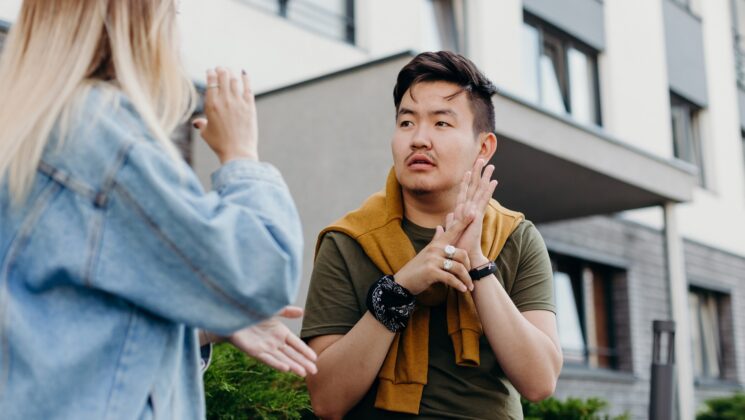A man and woman having a conversation in sign language