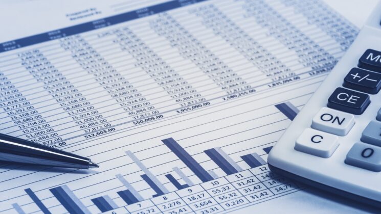 A spreadsheet, pen and calculator