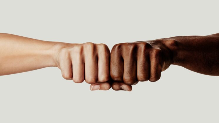 One white and one black fist together